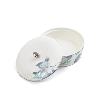 White ceramic container with floral design on a white background