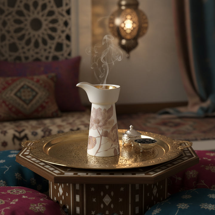 Decorative oil burner with smoke on a gold tray in a cozy room setting.