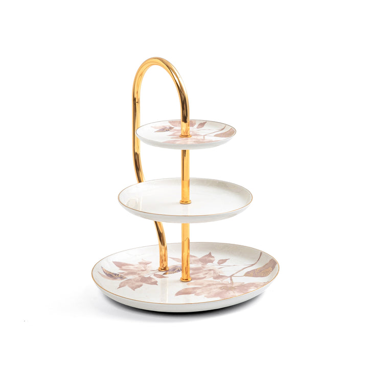 Three-tiered ceramic serving tray with floral design and gold accents on a white background