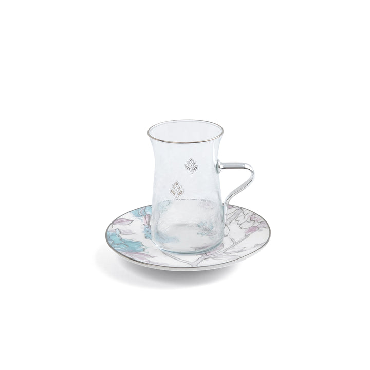 Clear glass teacup with handle and matching saucer on a white background