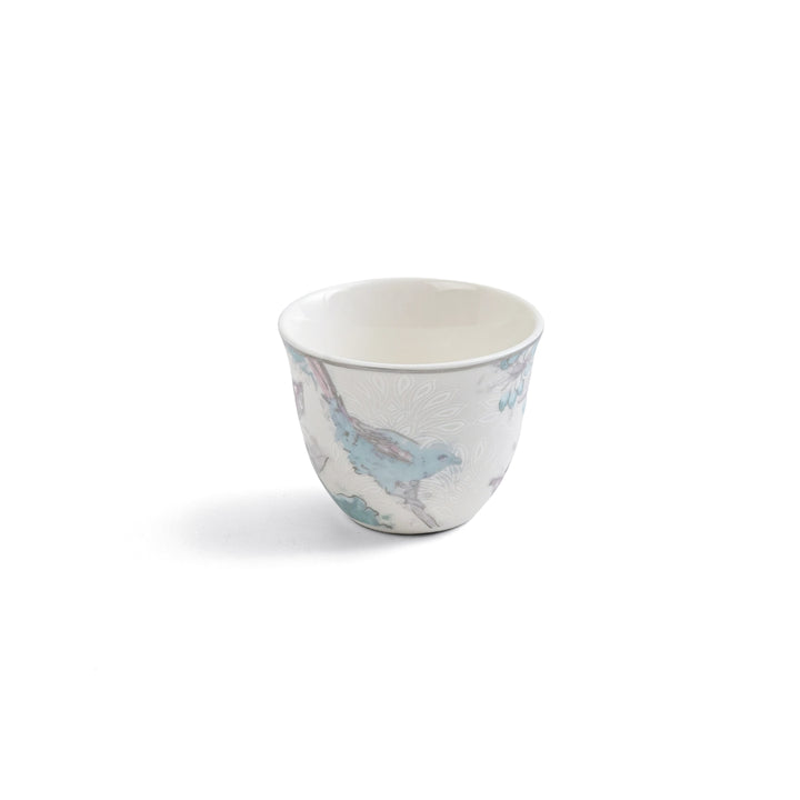 Small ceramic cup with a floral pattern on a white background