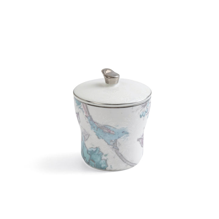 Ceramic jar with map design and silver lid on a white background