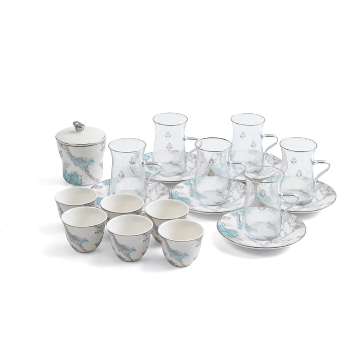 Tea set with ceramic and glass components on a white background