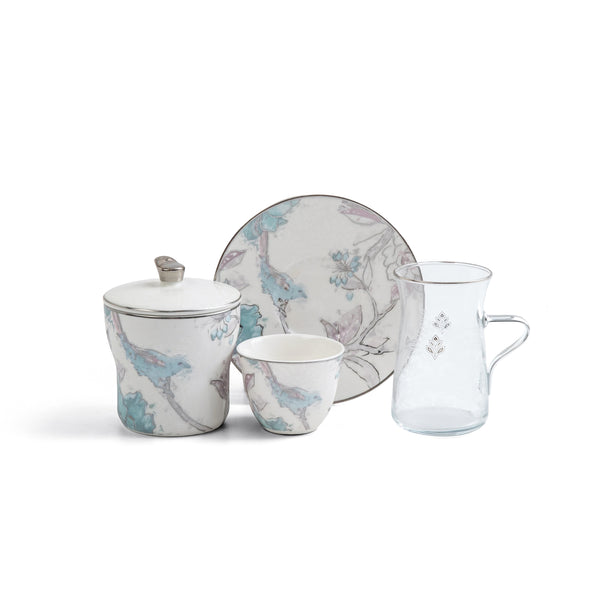 Ceramic tea set with floral patterns on a white background