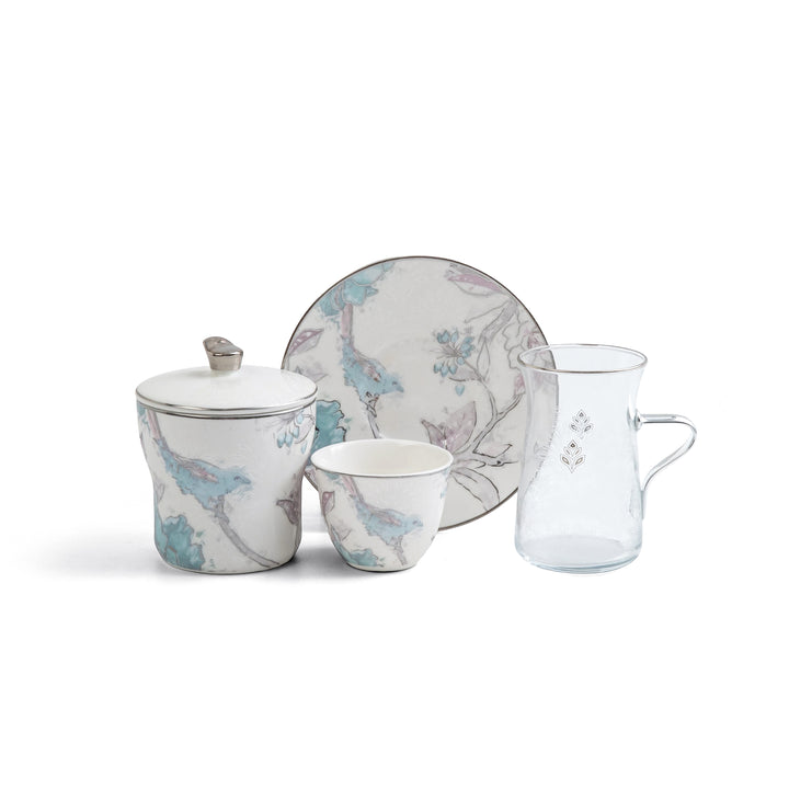 Ceramic tea set with floral patterns on a white background