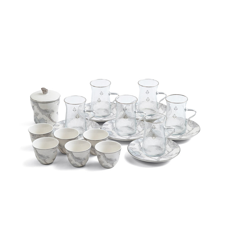 Ceramic and glass tea set with marble-like pattern on a white background