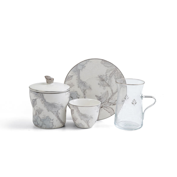 Set of ceramic tableware with floral patterns on a white background