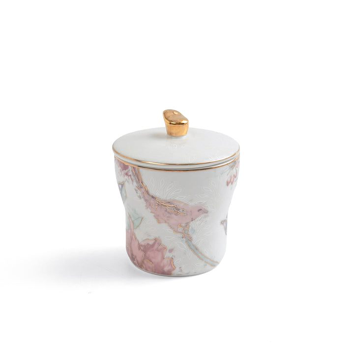 Marble-patterned container with a gold lid on a white background