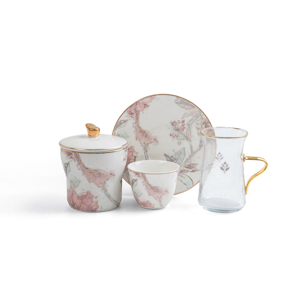 Ceramic tea set with floral design on a white background