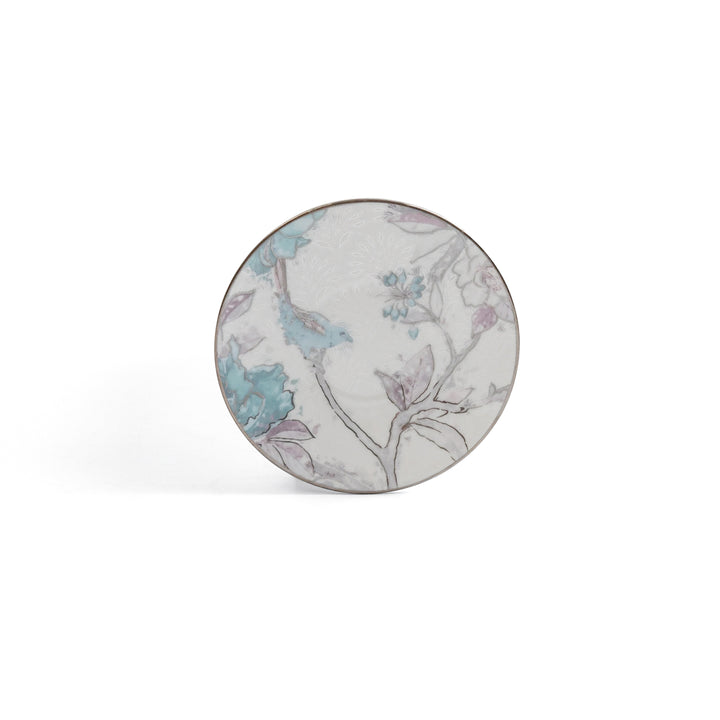 Round ceramic plate with floral pattern on a white background