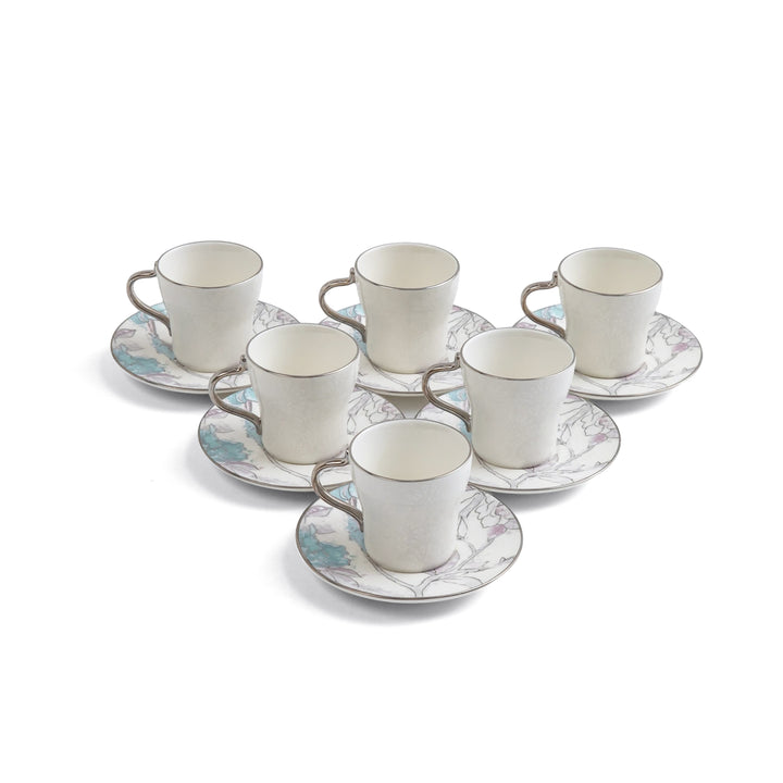 Set of six ceramic cups and saucers with decorative patterns on a white background
