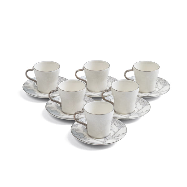 Set of six white ceramic cups with saucers on a white background