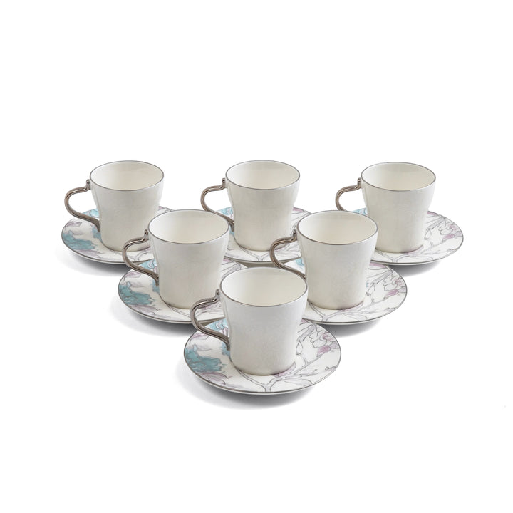 Set of six ceramic cups and saucers with floral patterns on a white background