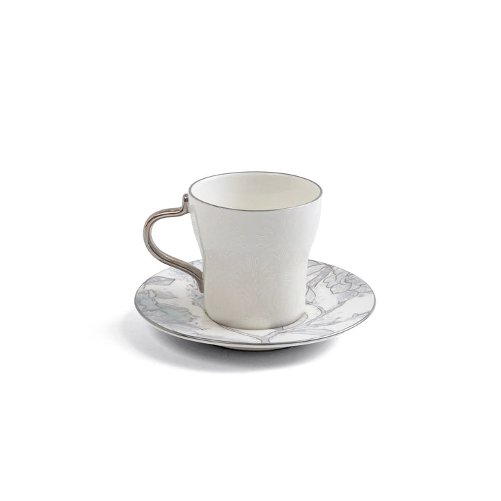 White ceramic cup and saucer with marble pattern on a white background