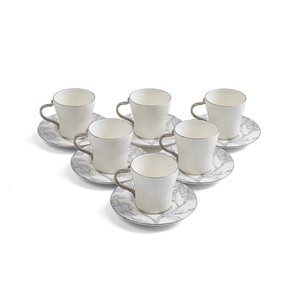 Set of six white ceramic cups with saucers on a white background