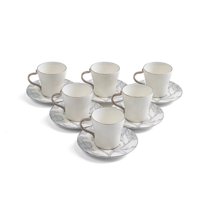 Set of six white ceramic cups with saucers on a white background