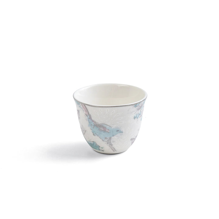 Small ceramic cup with a floral pattern on a white background