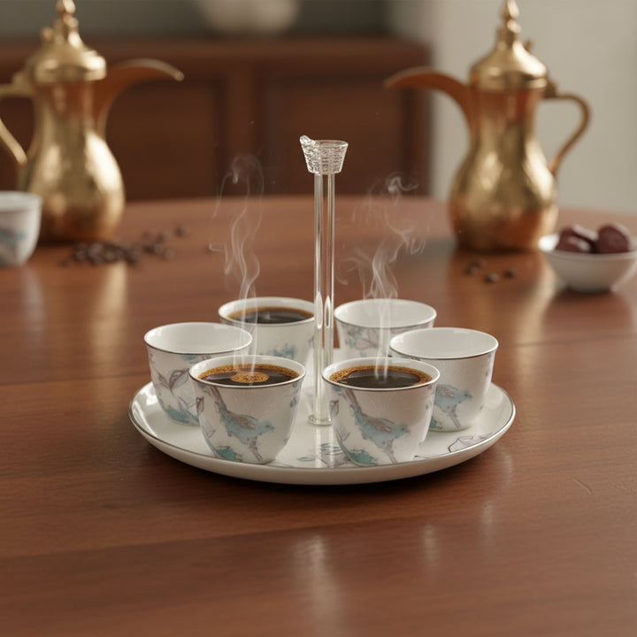 Set of six steaming cups on a tray with gold teapots in the background