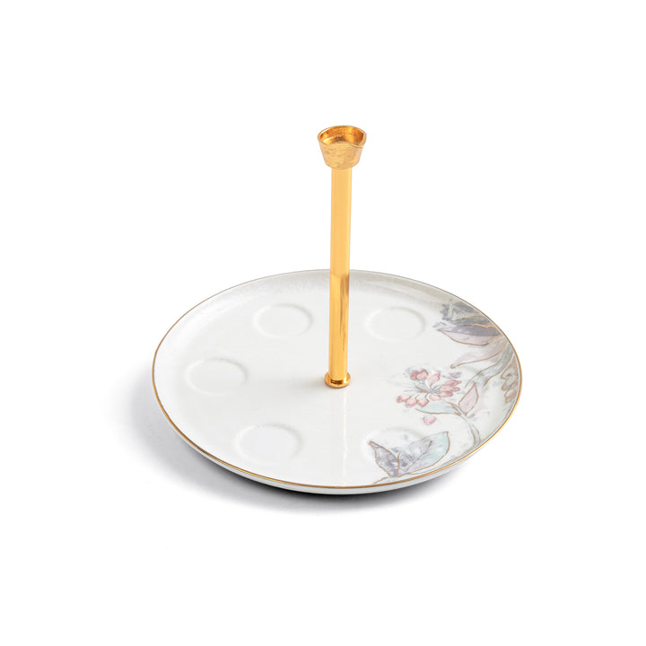 Decorative jewelry stand with floral design and gold rod on a white background