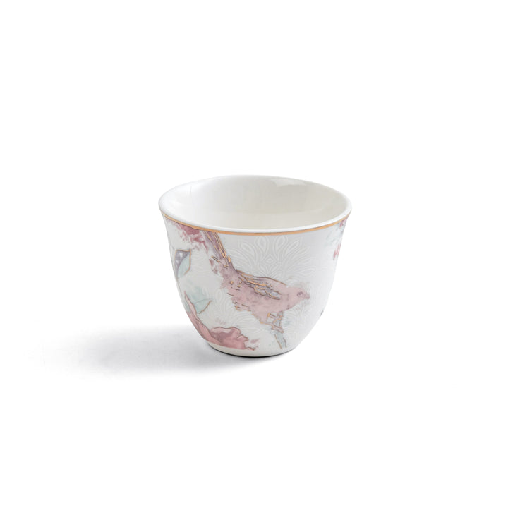 Small ceramic cup with a pink and white pattern on a white background
