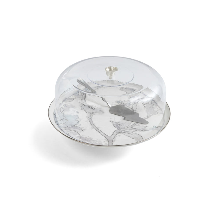 Glass cake stand with floral design on a white background