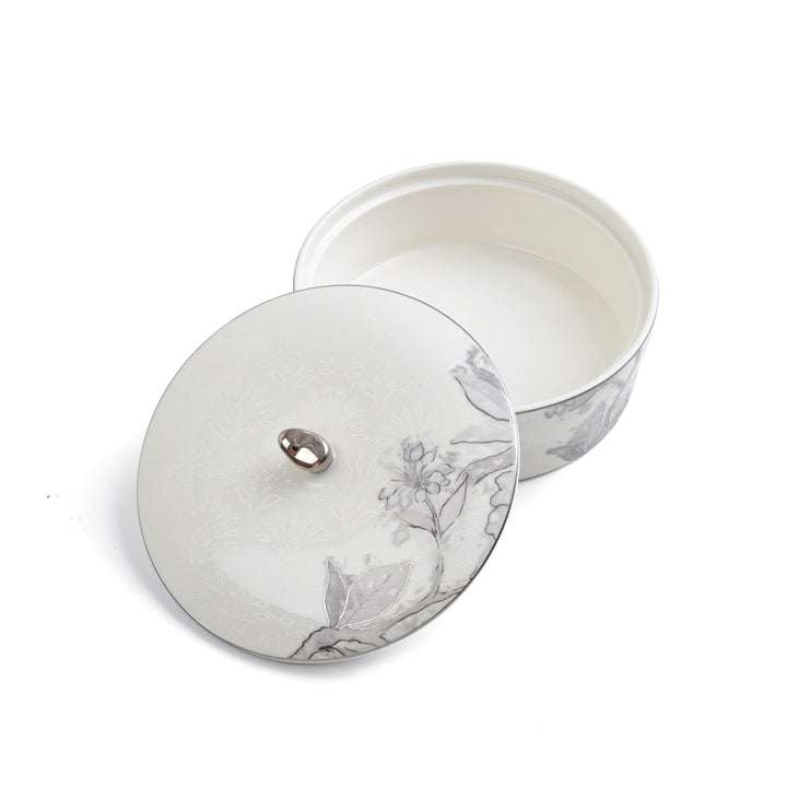Round ceramic container with floral design on a white background