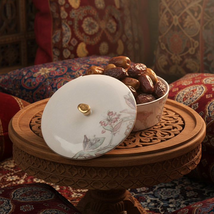 Decorative teapot with floral lid on a wooden stand against a patterned fabric background
