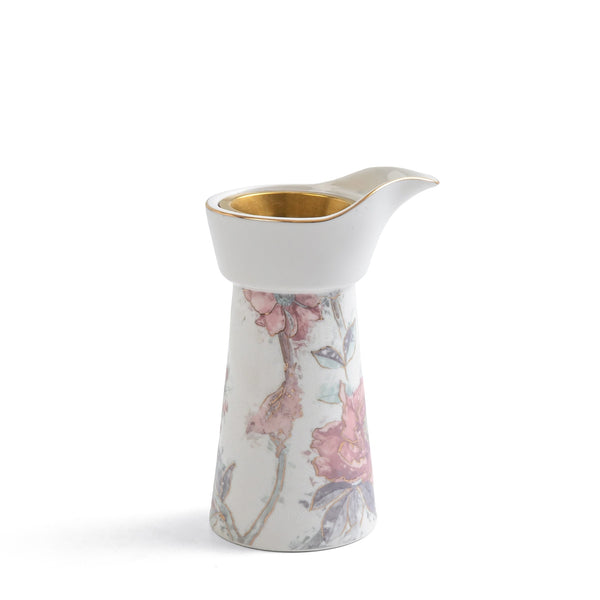 Decorative ceramic pitcher with floral design on a white background
