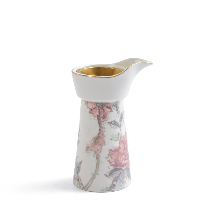 Decorative ceramic pitcher with floral design on a white background