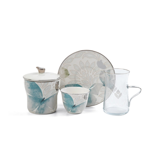 Ceramic tea set with floral design on a white background