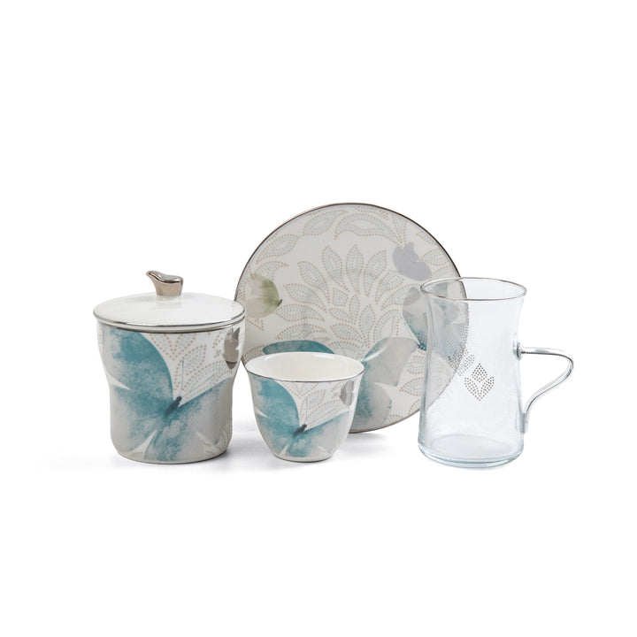Ceramic tea set with floral design on a white background