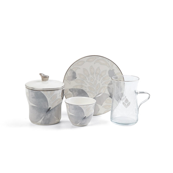 Set of ceramic tableware with floral patterns on a white background