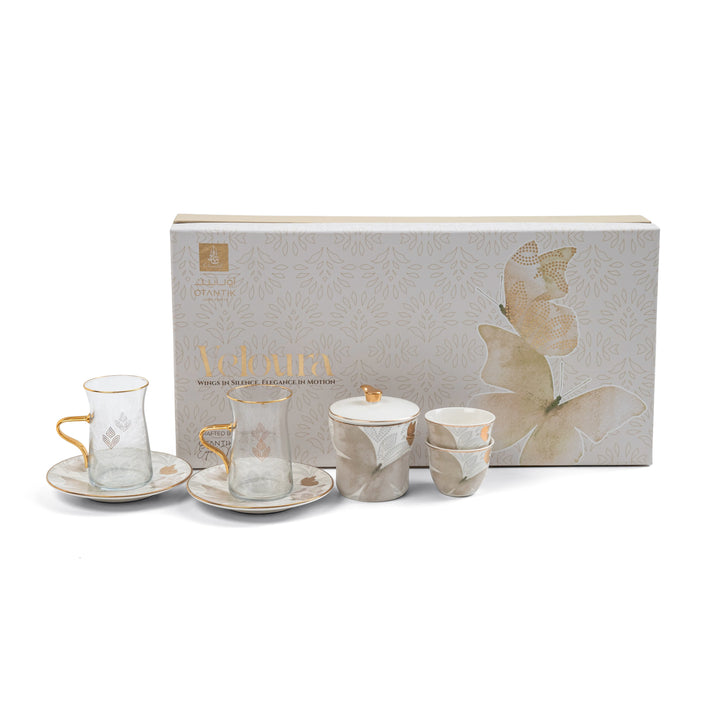 Ceramic tea set with saucers and a decorative box on a white background
