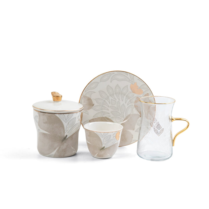 Ceramic tea set with floral design on a white background