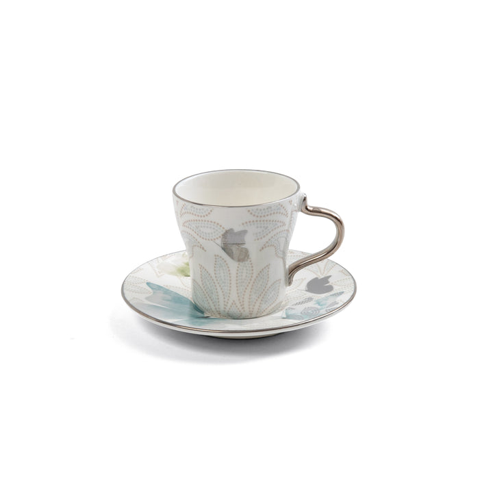 Ceramic cup and saucer with floral design on a white background