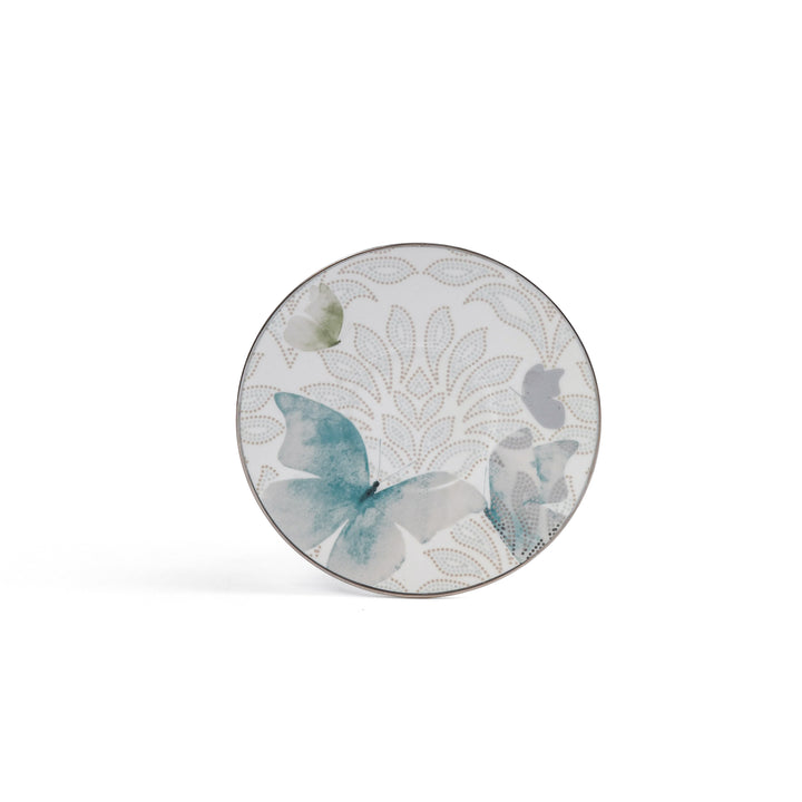 Round ceramic plate with butterfly design on a white background