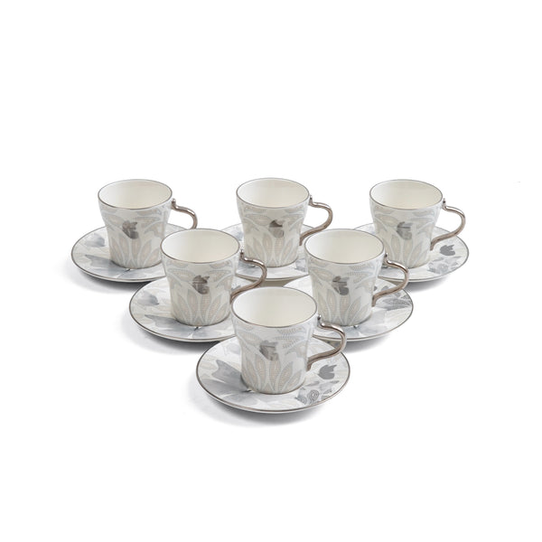 Set of six ceramic cups and saucers with a floral pattern on a white background