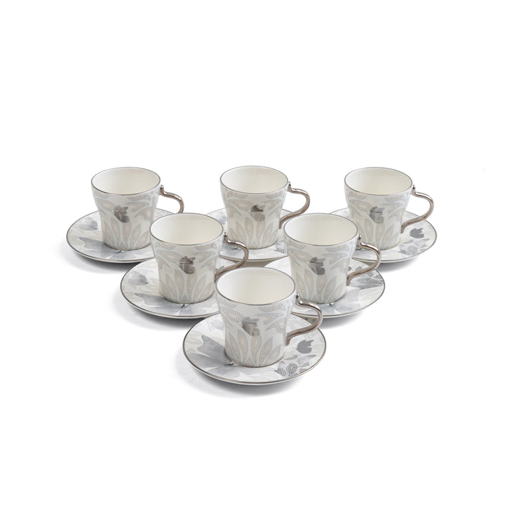 Set of six ceramic cups and saucers with a floral pattern on a white background