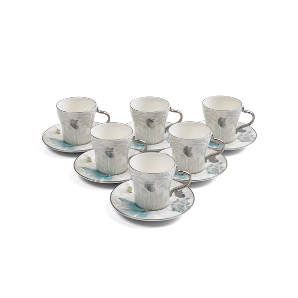 Set of six ceramic cups and saucers with decorative patterns on a white background