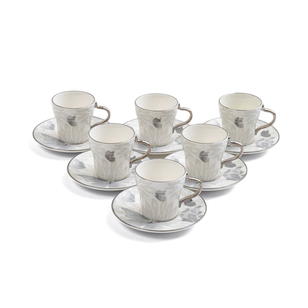 Set of six ceramic cups and saucers with a marble-like pattern on a white background