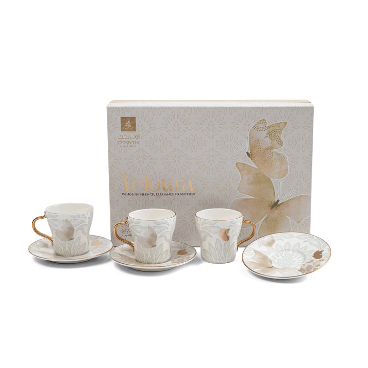 Ceramic tea set with butterfly design on a white background
