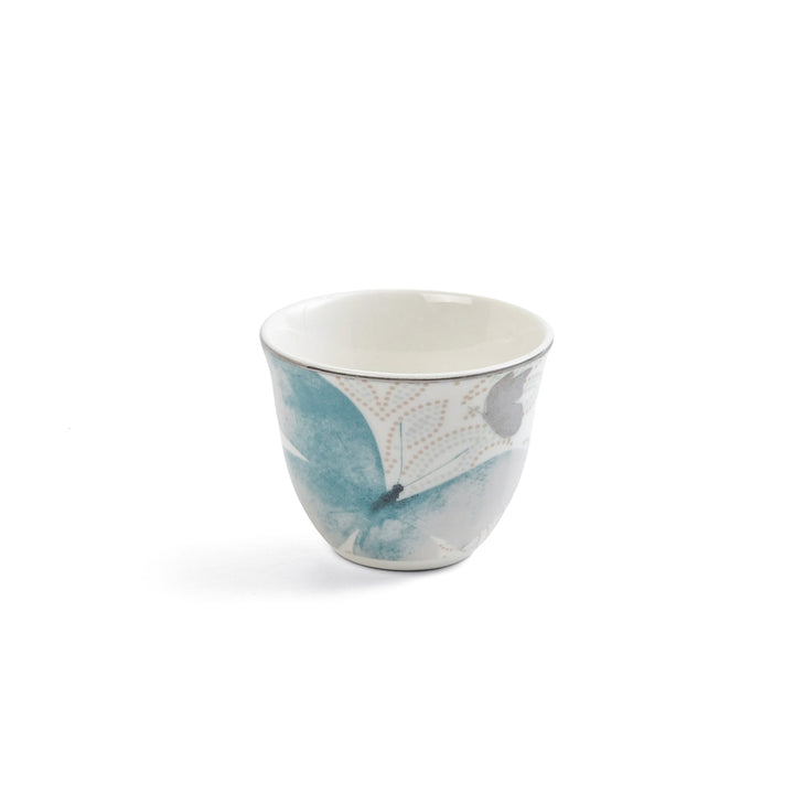 Ceramic cup with blue and gray abstract design on a white background