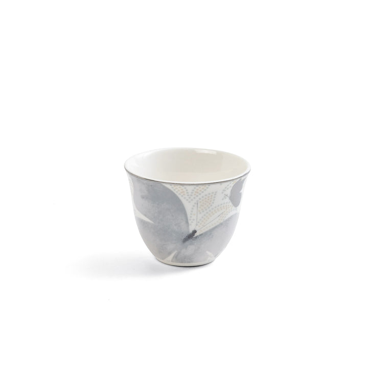 Ceramic cup with gray and white marbled design on a white background