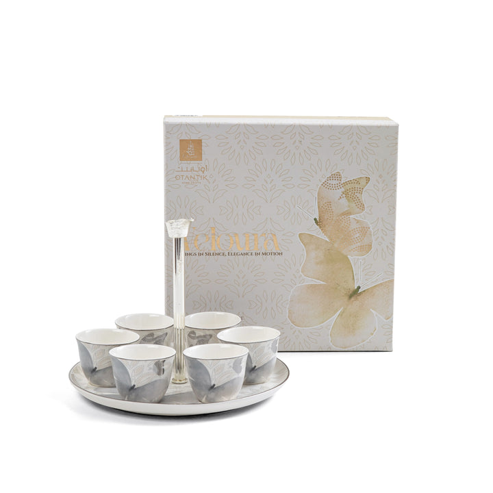 Set of ceramic cups with a tray and a branded box on a white background