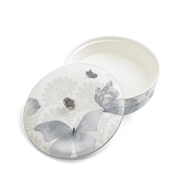 Decorative ceramic container with butterfly design on a white background