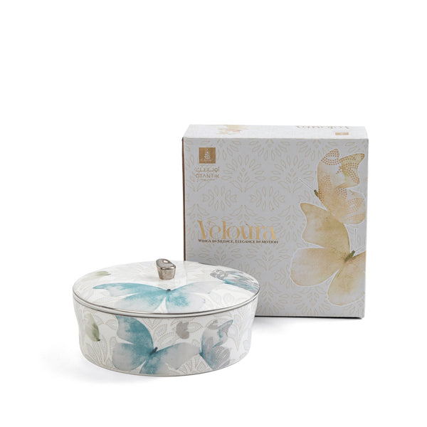 Decorative ceramic container with butterfly design and matching box on a white background