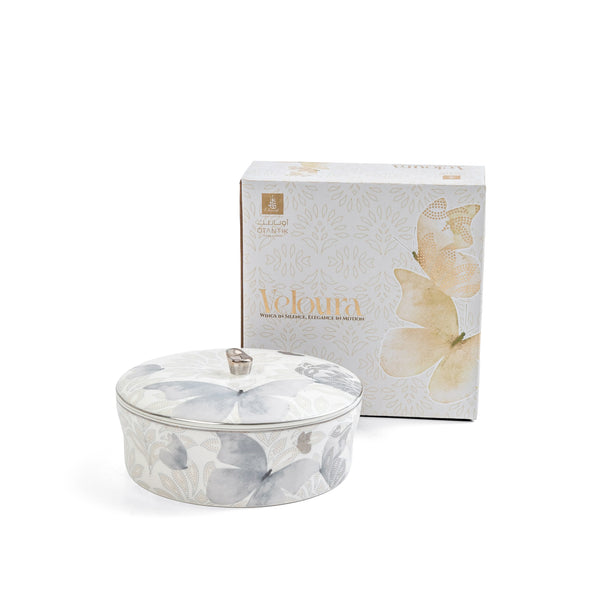Candle with floral design and matching box on a white background