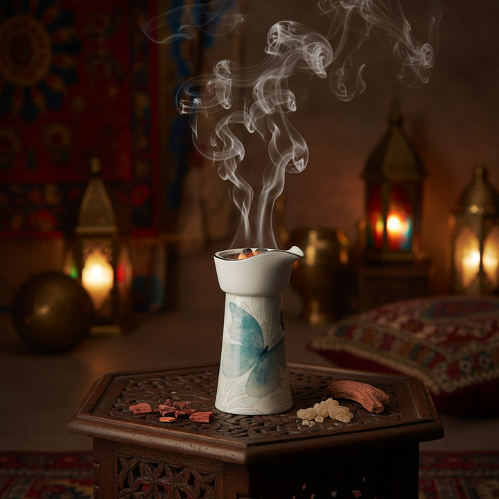 Decorative incense burner with smoke in a warm, blurred interior setting