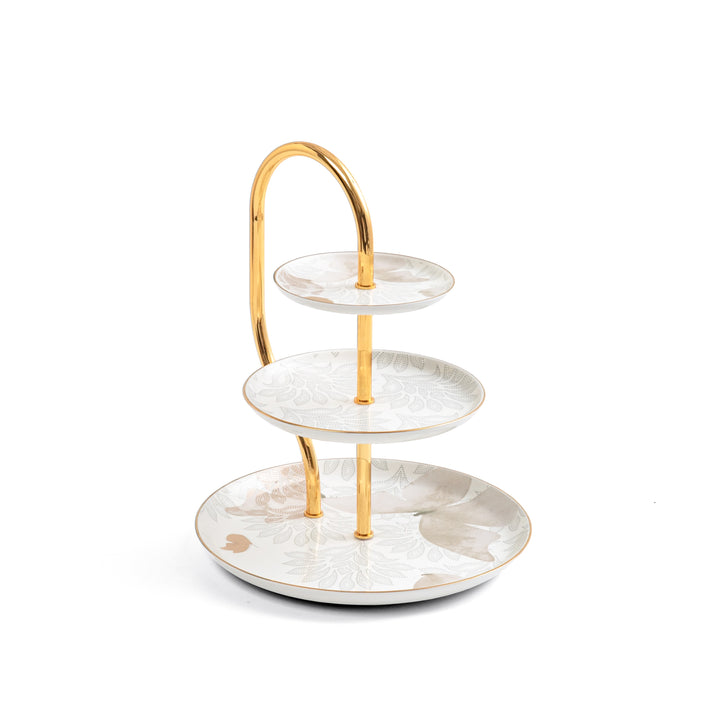 Three-tiered ceramic dessert stand with gold accents on a white background
