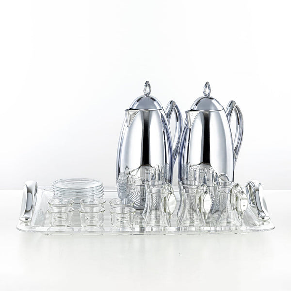 Silver tea set with teapot, coffee pot, and glasses on a white background